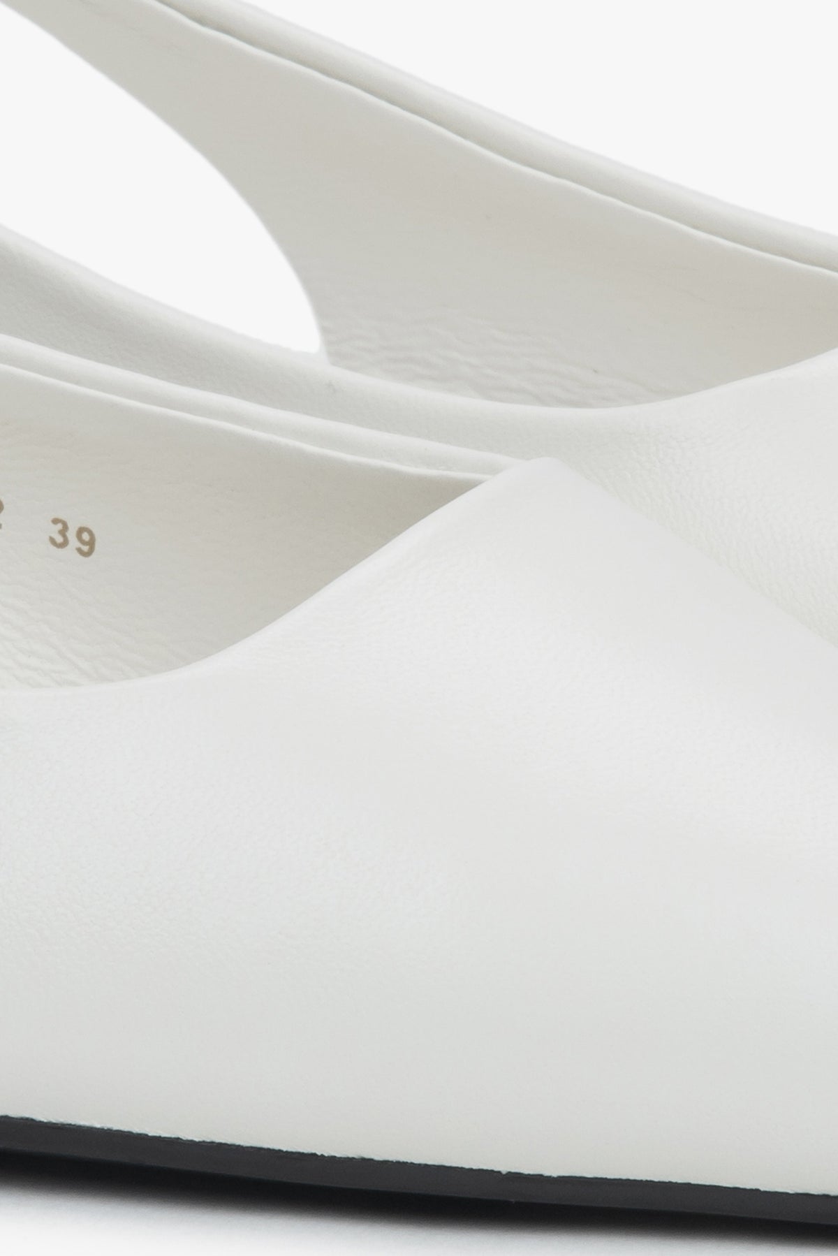 Stylish women's slingback sandals with white detailing and a pointed toe.