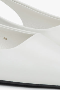 Stylish women's slingback sandals with white detailing and a pointed toe.