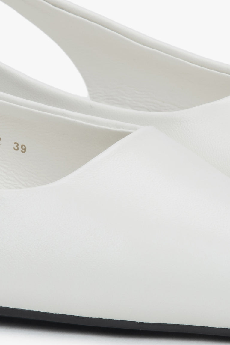 Stylish women's slingback sandals with white detailing and a pointed toe.