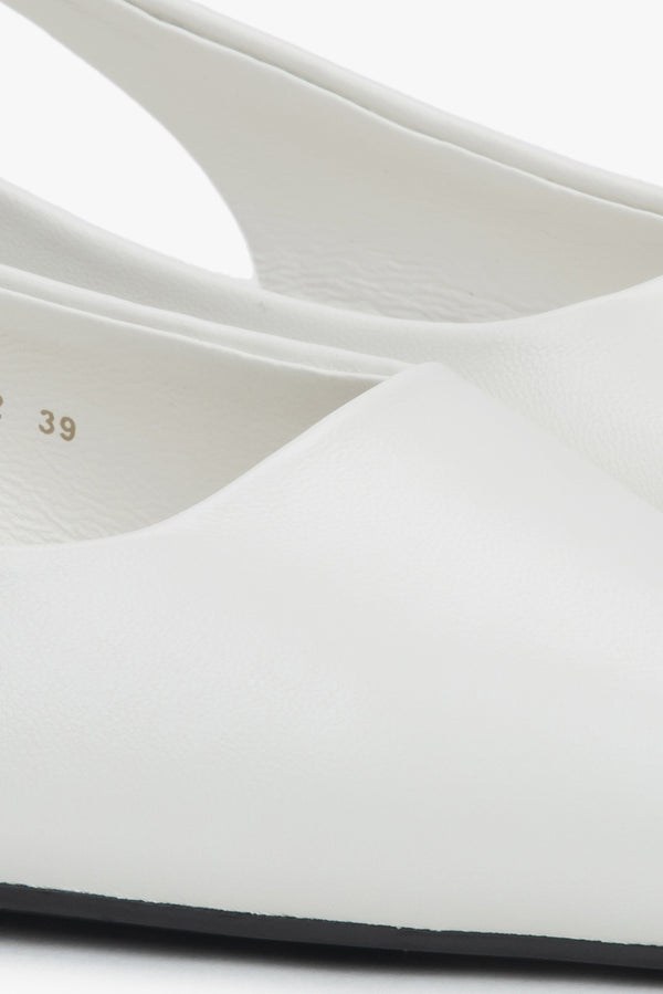 Stylish women's slingback sandals with white detailing and a pointed toe.