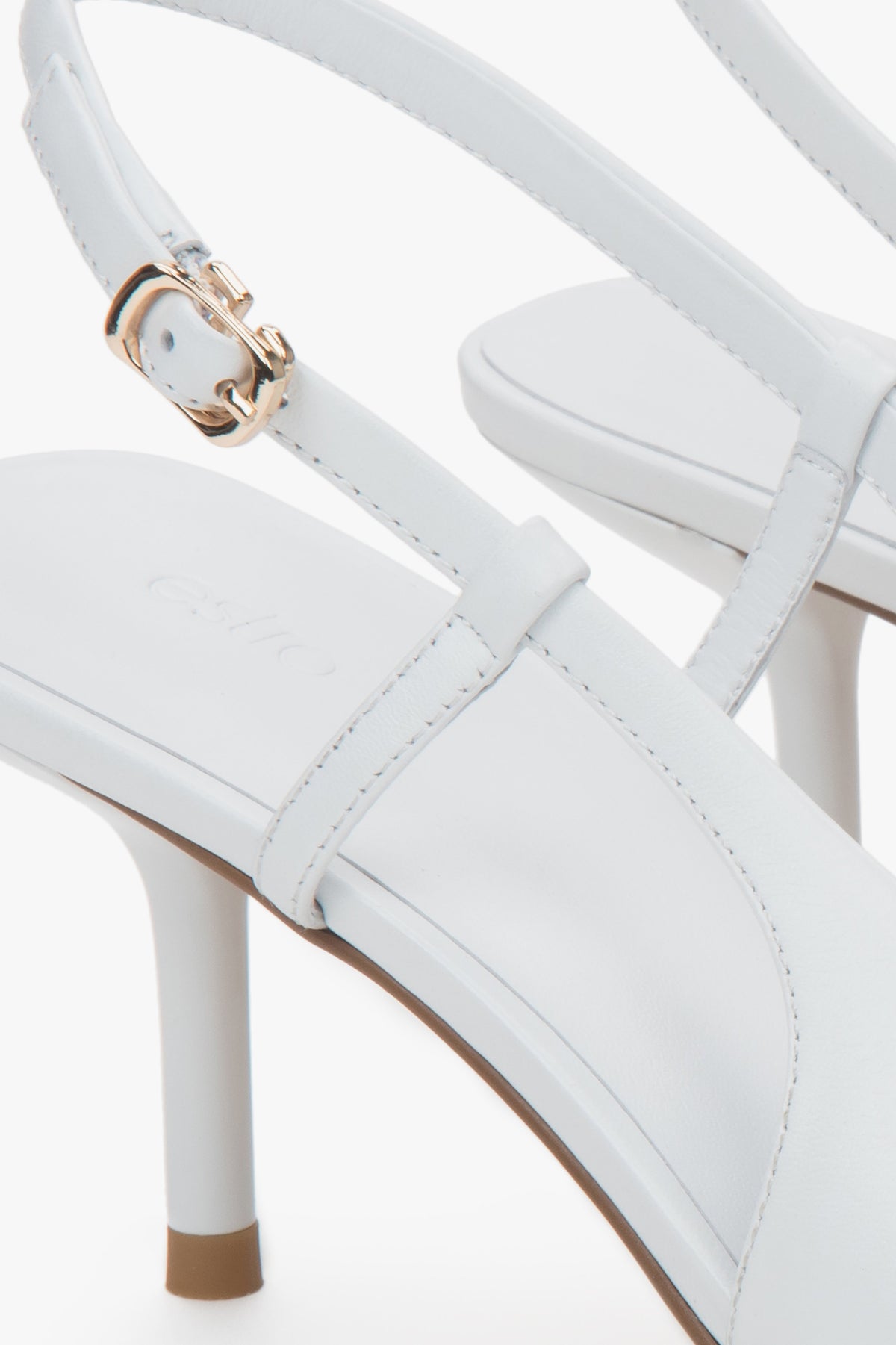 White women’s Estro slingback pumps with an open heel and a stable stiletto heel.