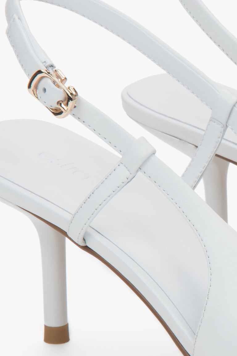 White women’s Estro slingback pumps with an open heel and a stable stiletto heel.