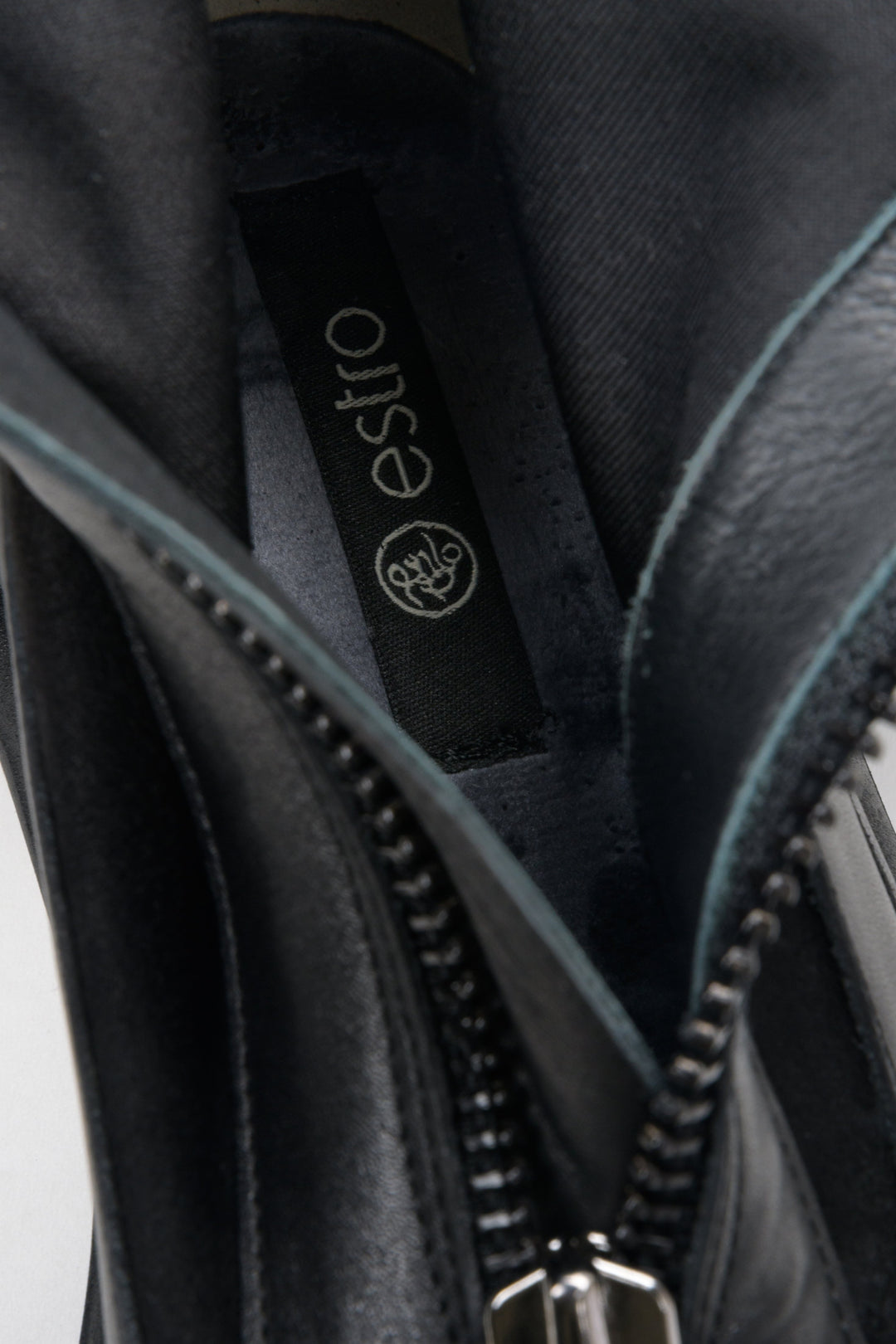 Black knee-high leather and velour boots - a close-up on details.