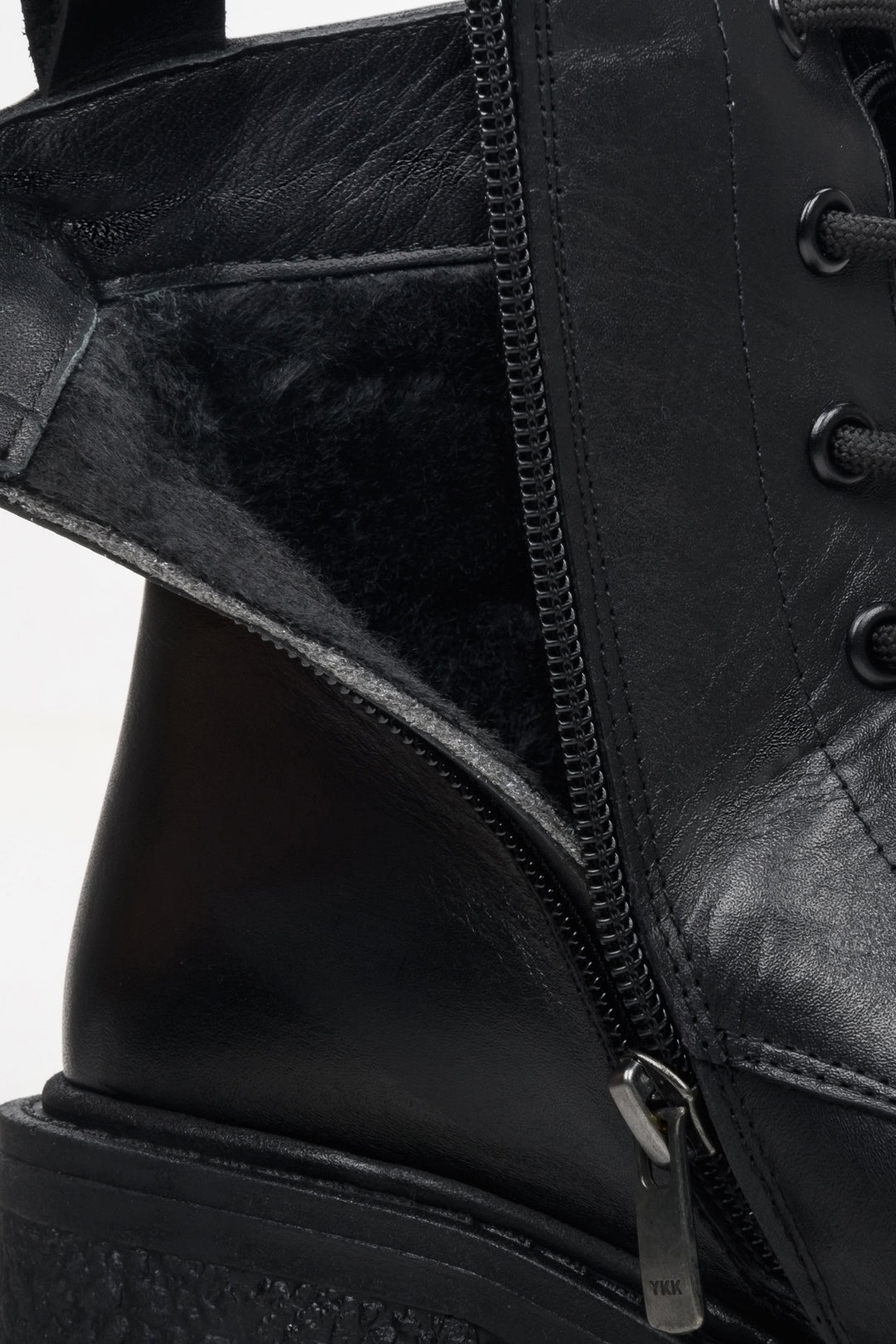 Black leather Estro women's ankle boots with a stable heel - close-up of the instep.