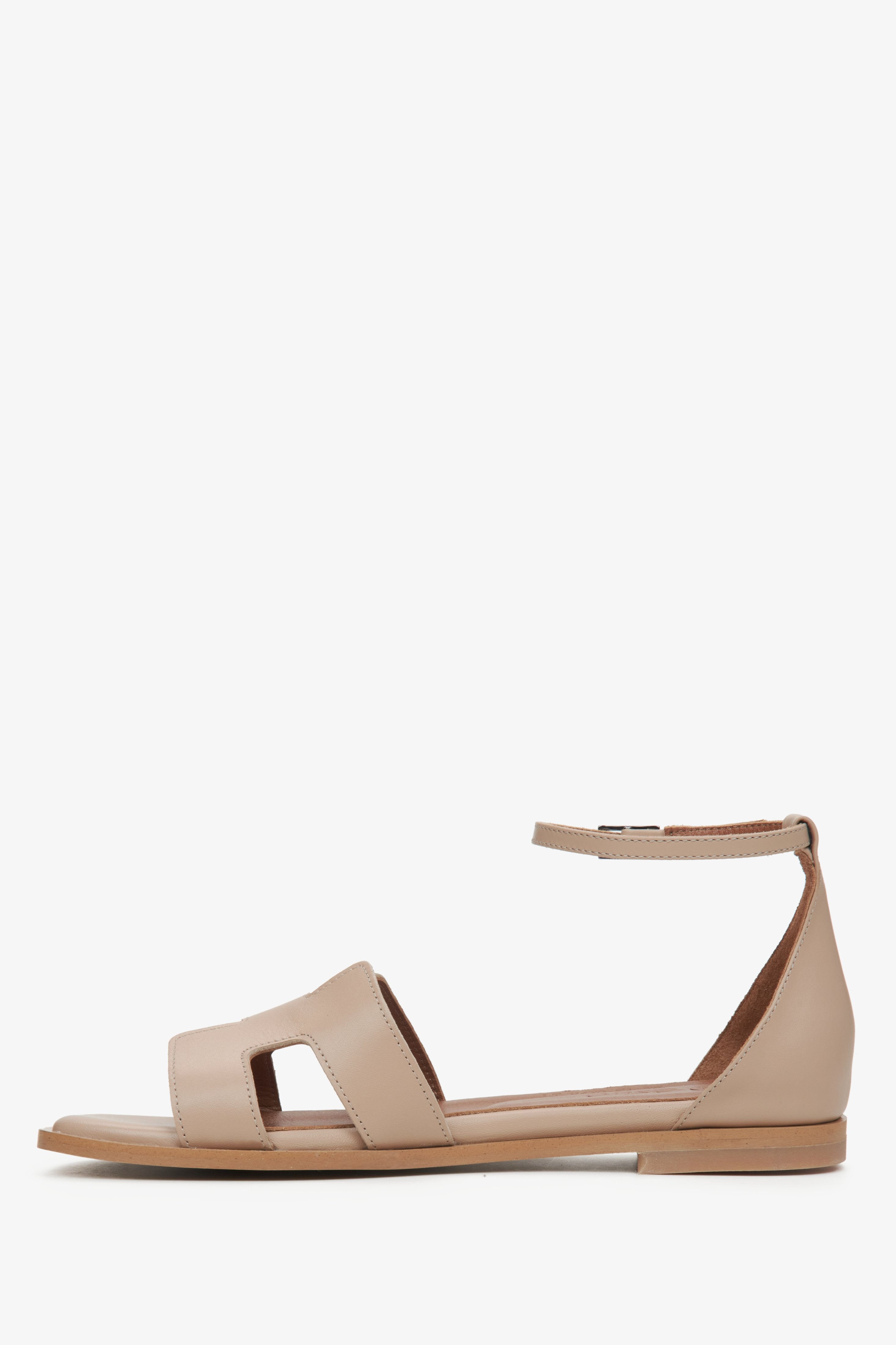 Women's beige sandals - side view.