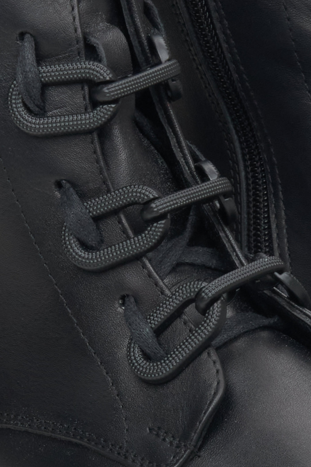Women's black leather insulated ankle boots - a close-upon details.