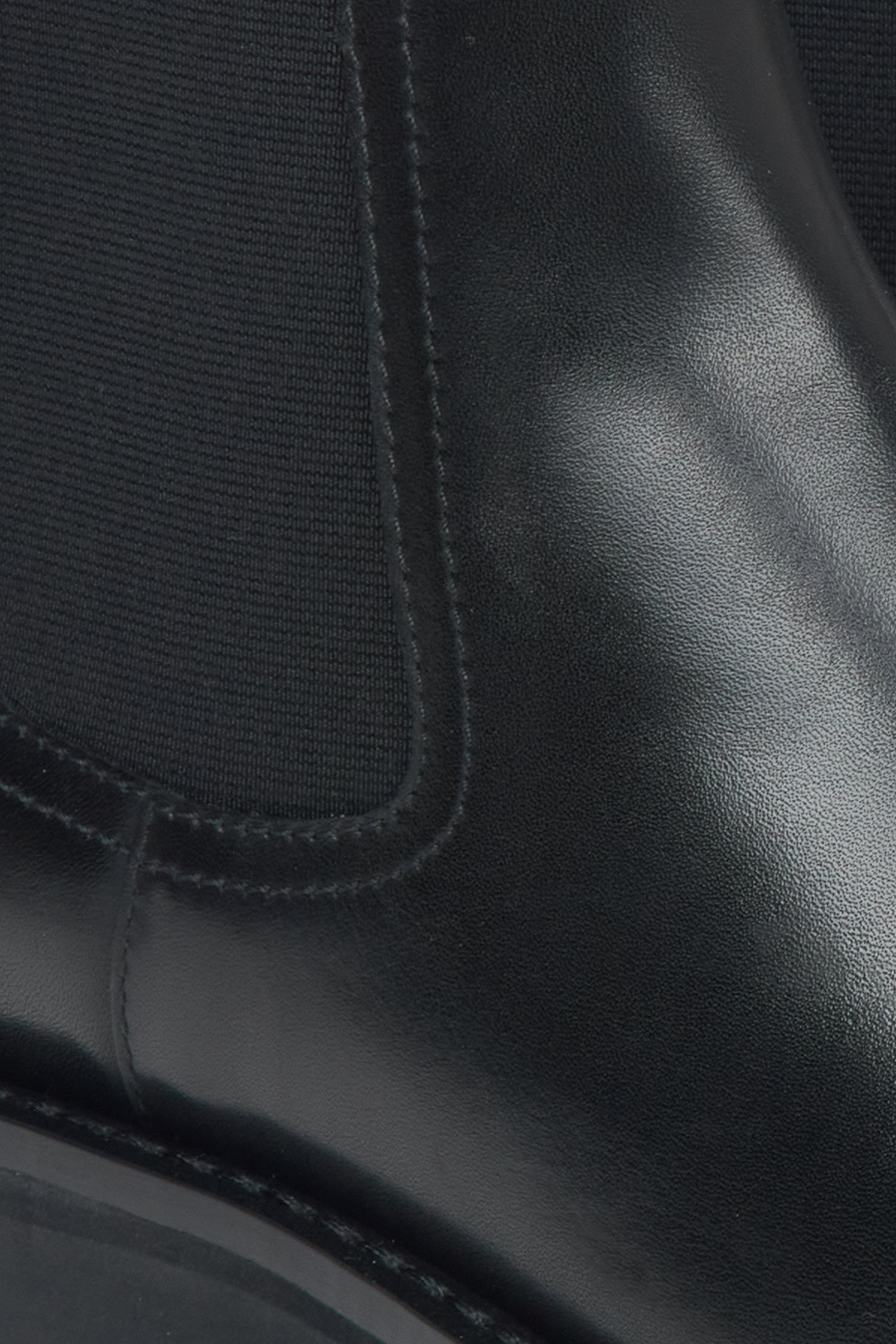 Elegant black low Chelsea boots for women made of genuine leather by Estro - close-up of the details.