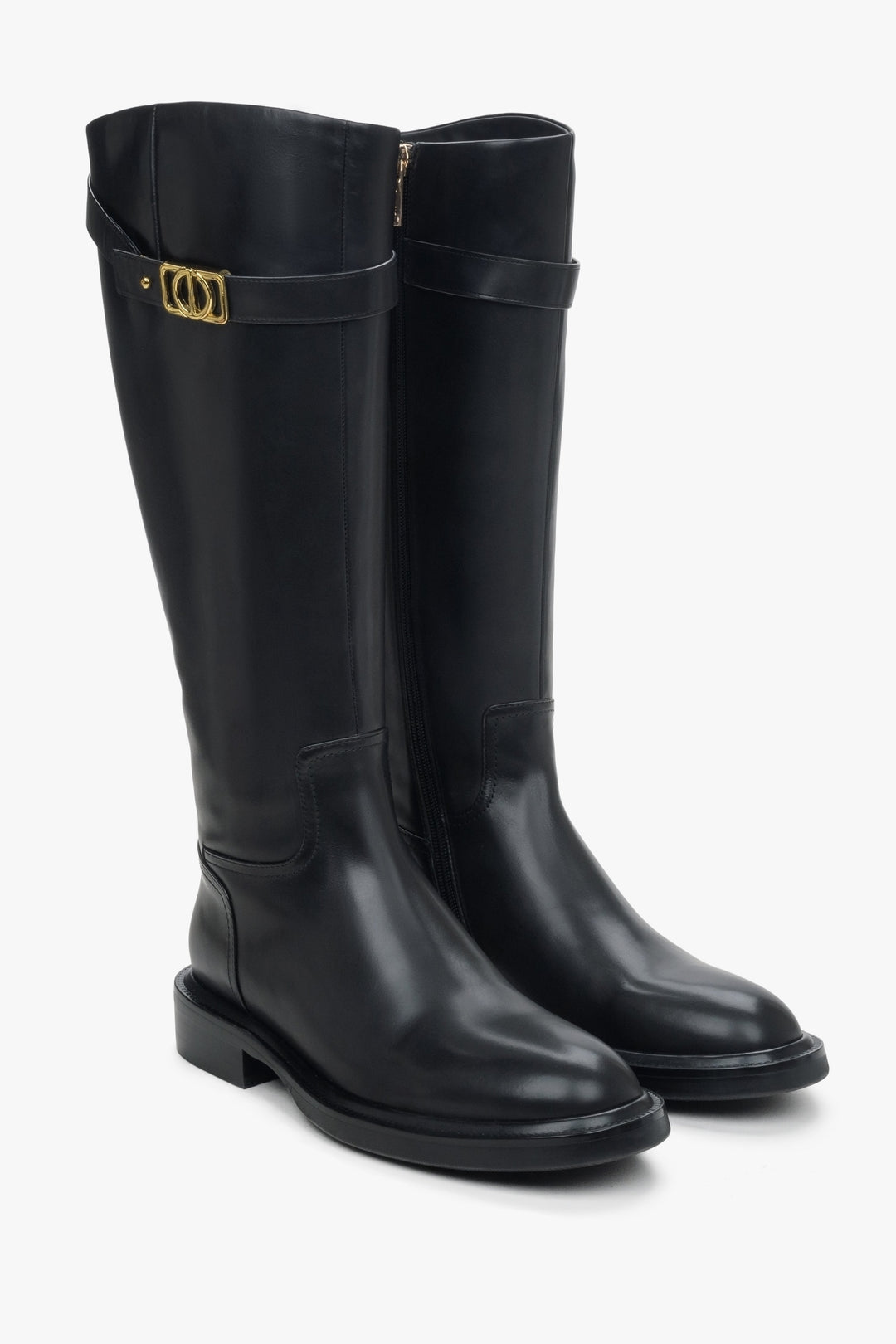 Women's black leather boots with a decorative strap.