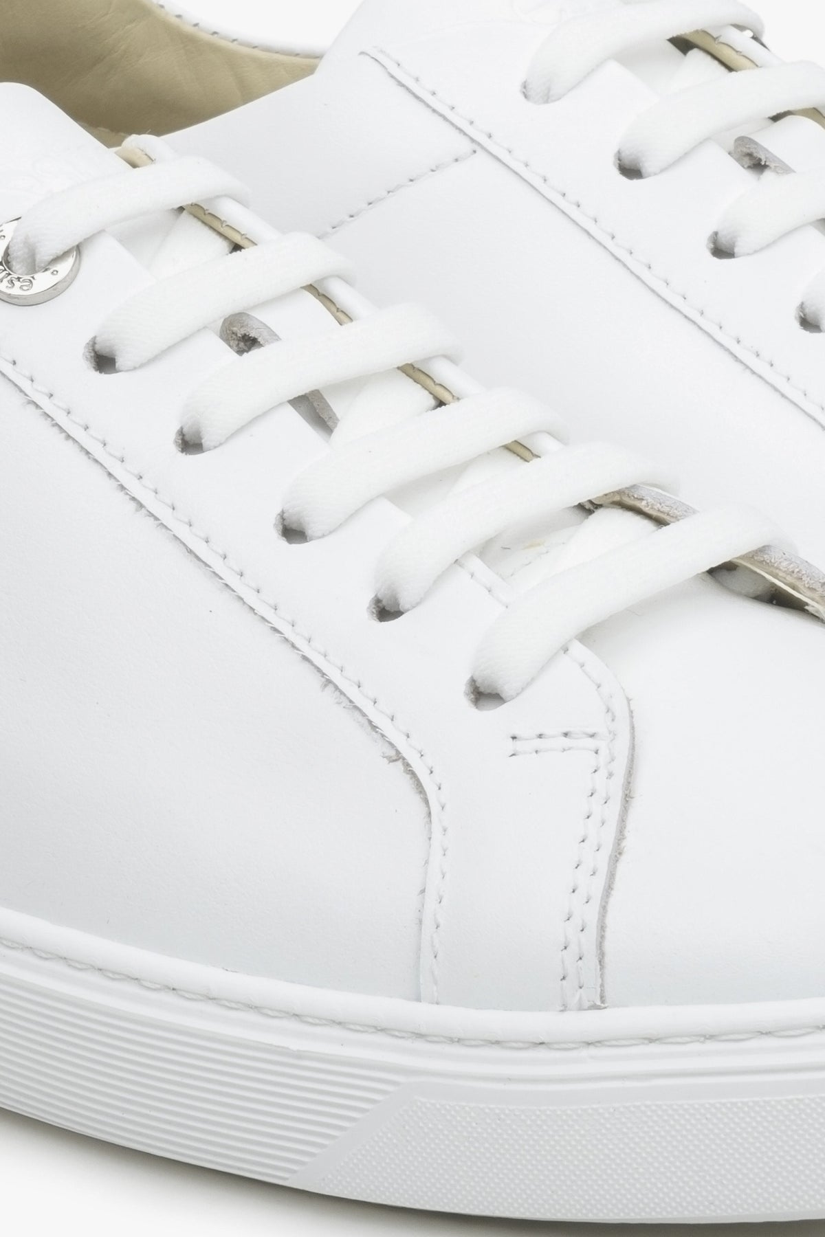 Women's white leather sneakers by Estro with laces for fall - close-up on the details.