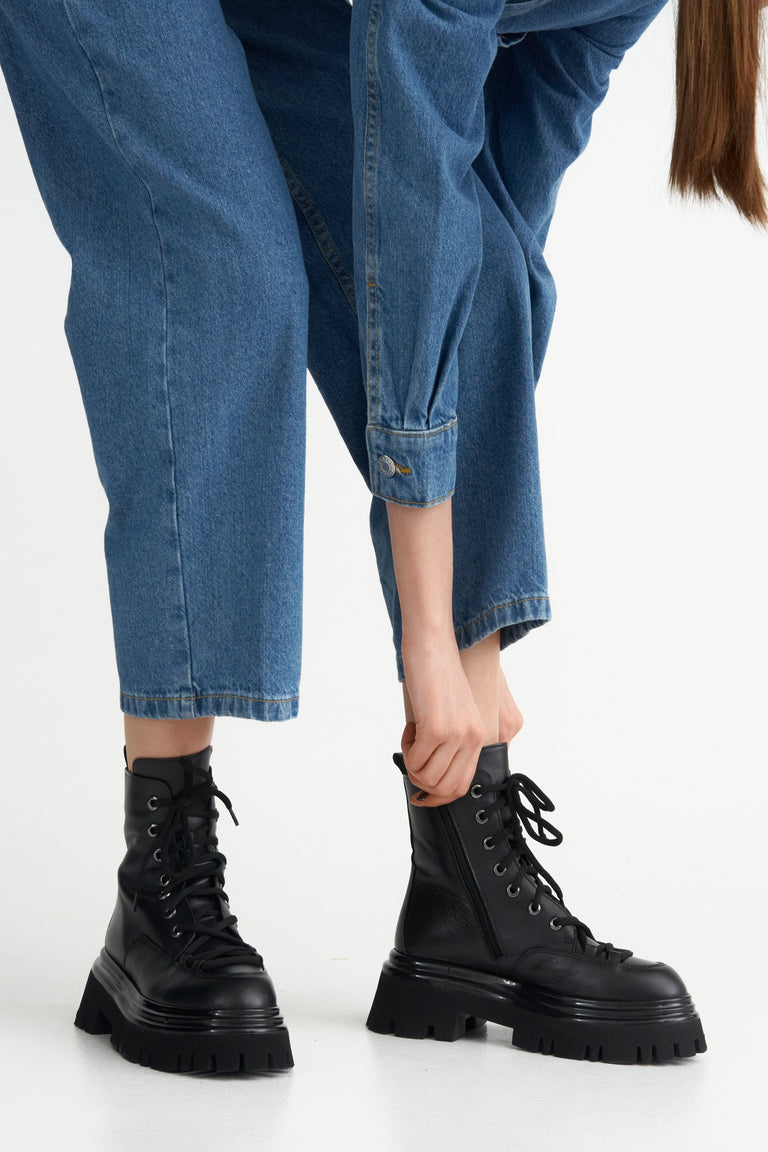 Lace-up women's ankle boots - footwear presentation on a model.