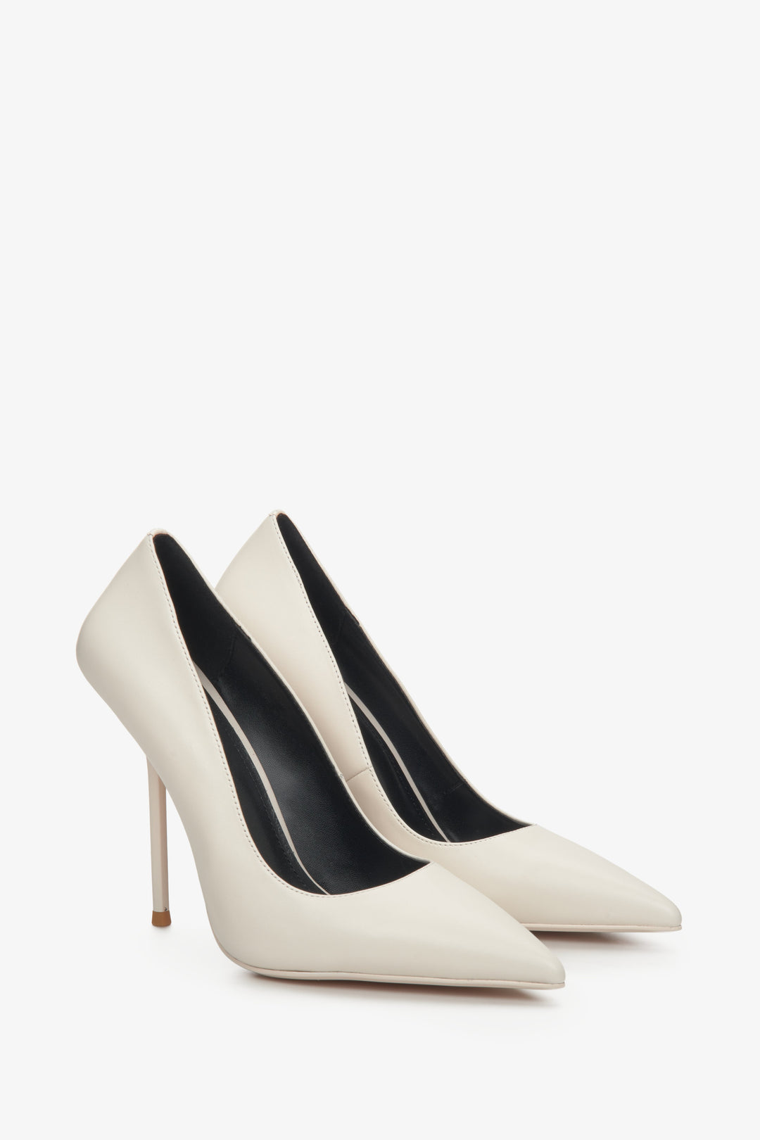 Women's white leather stiletto heels with a pointed toe.
