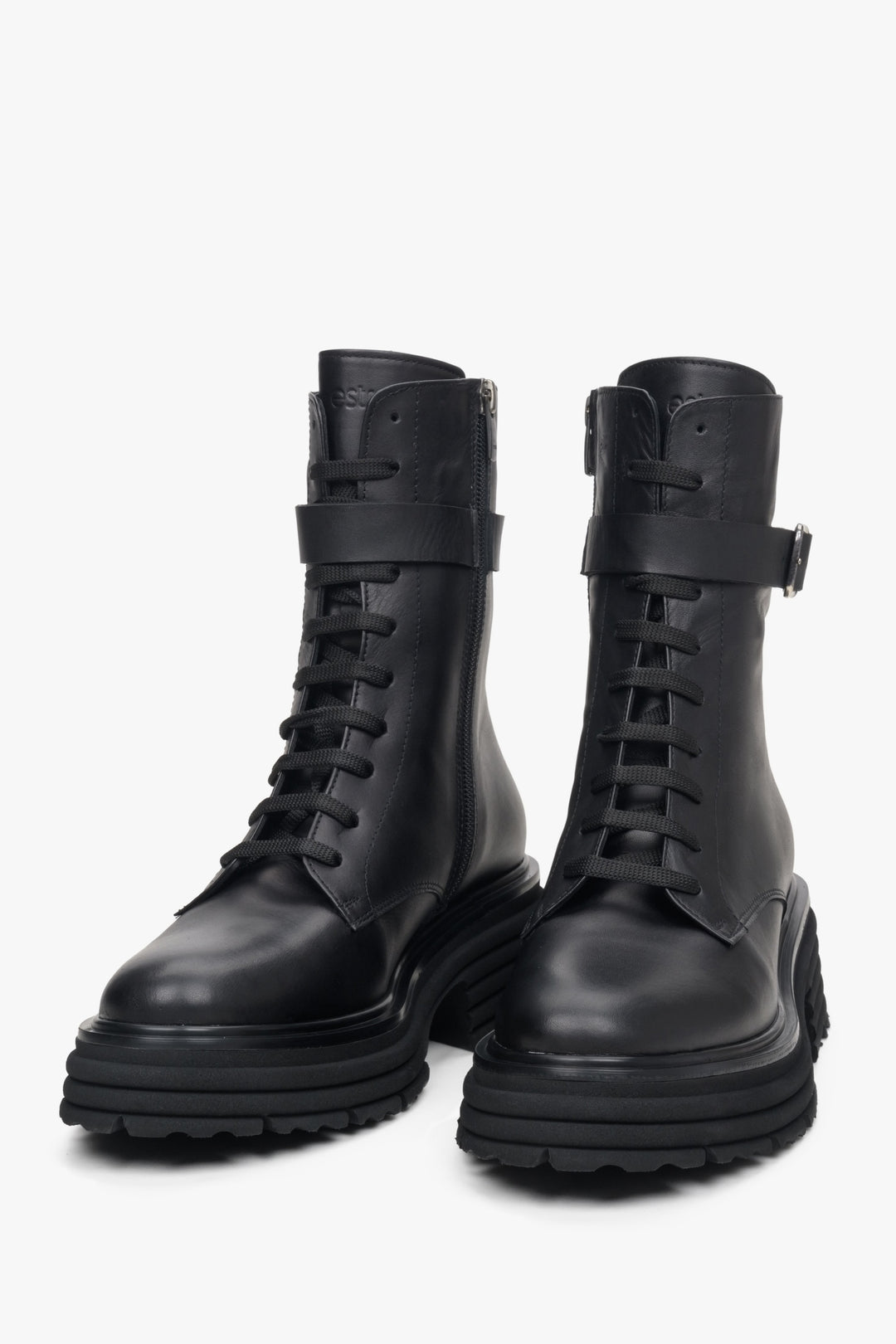 Women's black boots by Estro with a decorative strap - front view of the model.