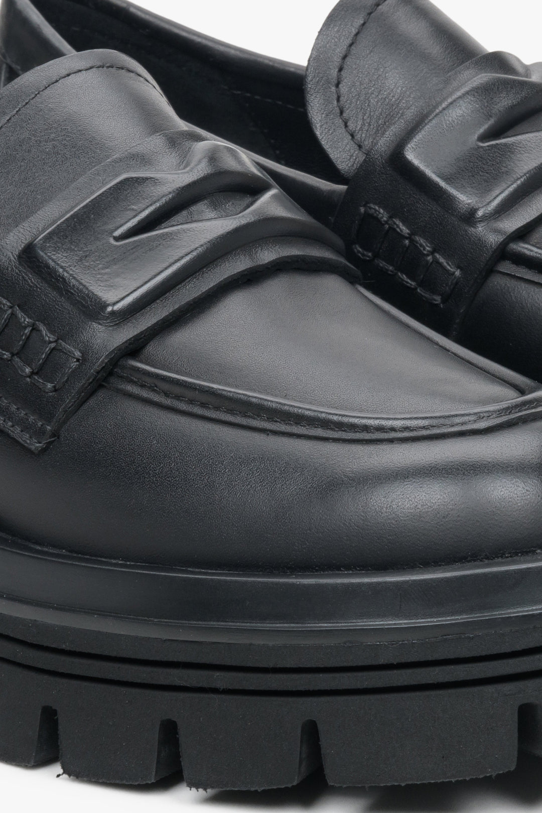 Women's slip-on black moccasins by Estro - close-up on details.