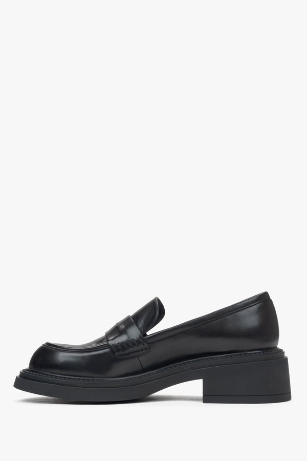 Side profile view of women's black penny loafers with a square heel.