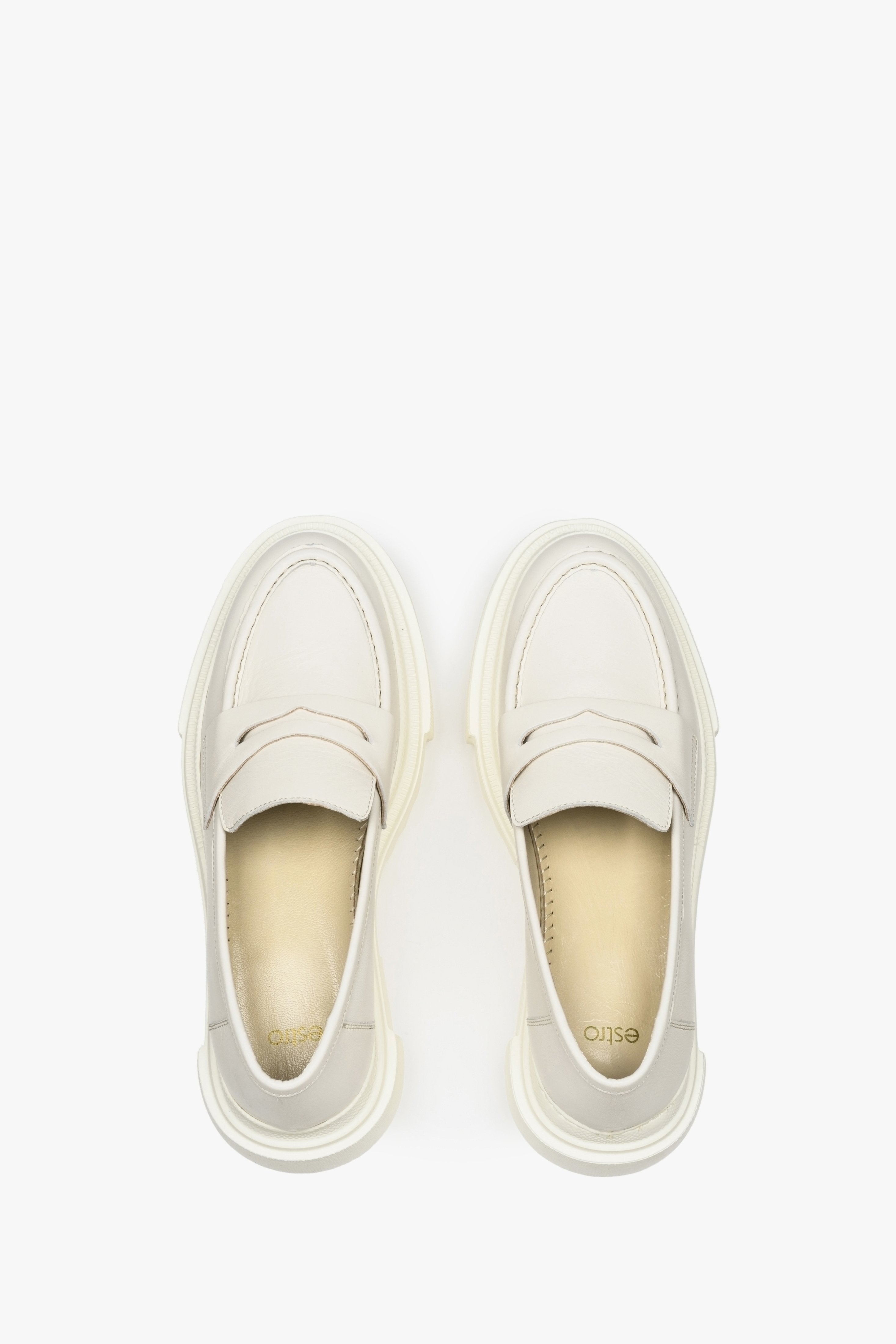 Elegant leather loafers in white - presentation of the footwear from above.