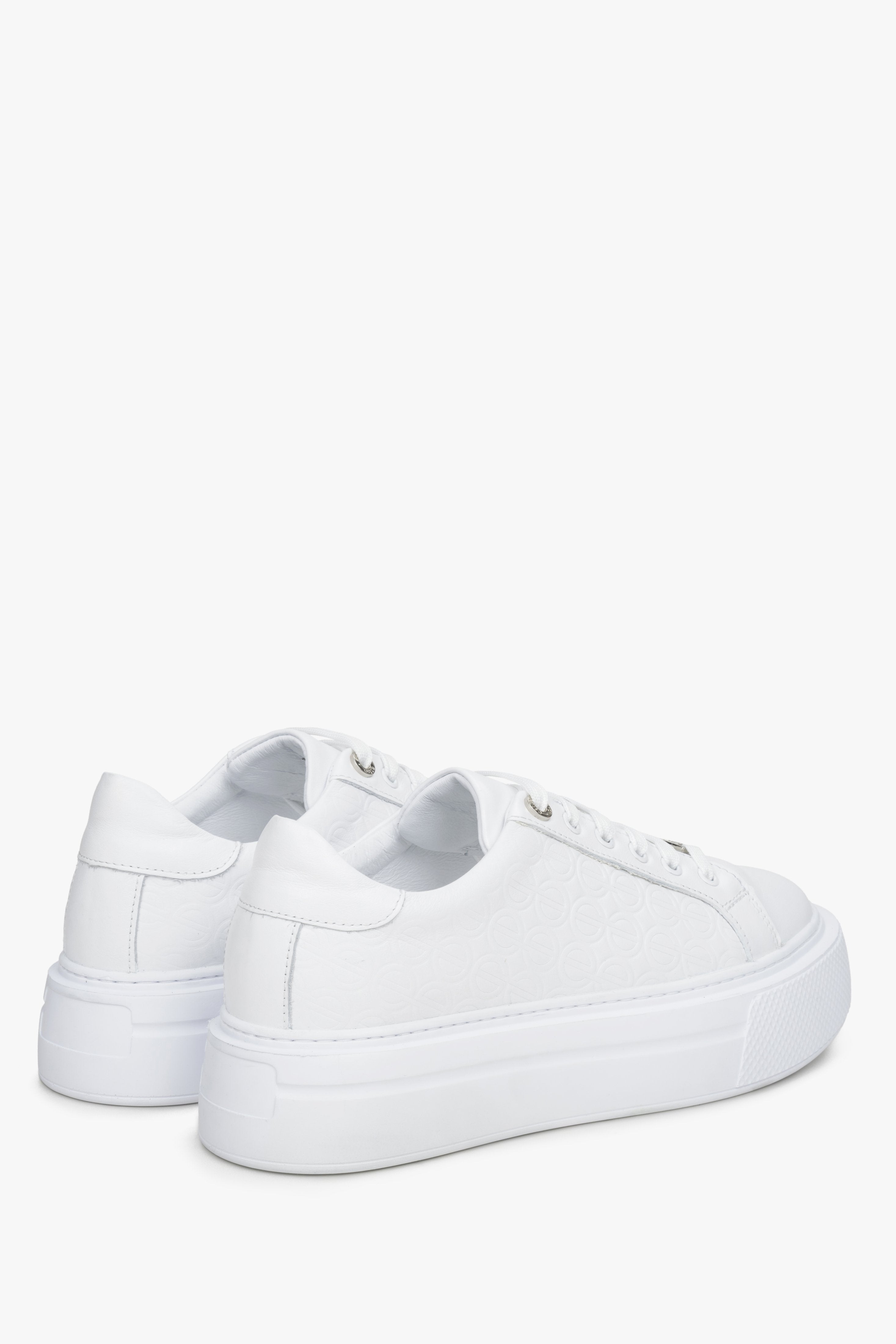 Women's white  leather sneakers by Estro - close-up on the side line and heel counter.