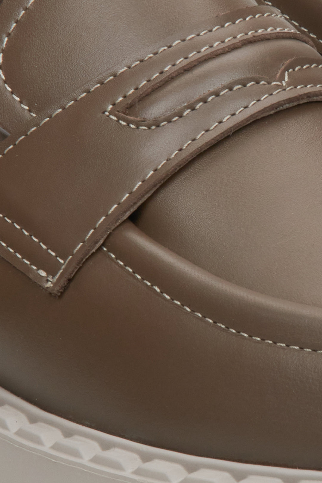 Loafers crafted from rich brown leather - close-up on a heel counter.
