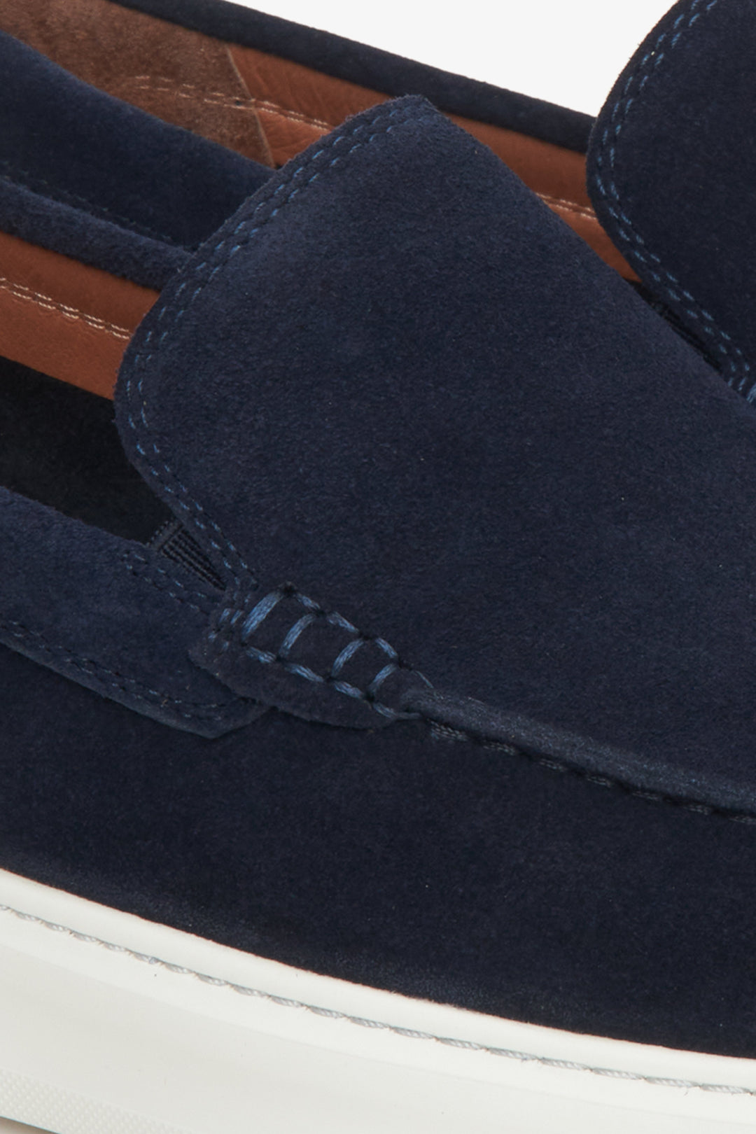 Navy blue men's velour loafers - close-up on the stitching detail.