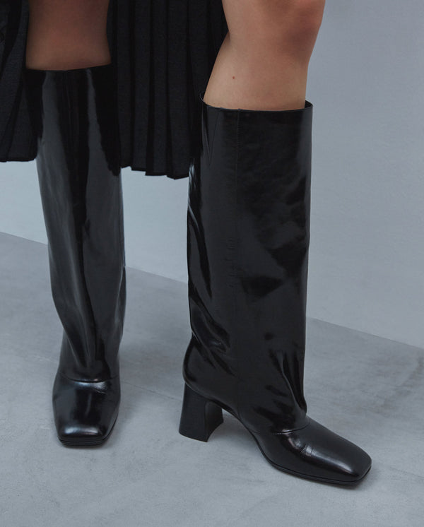 Black patent leather high boots.