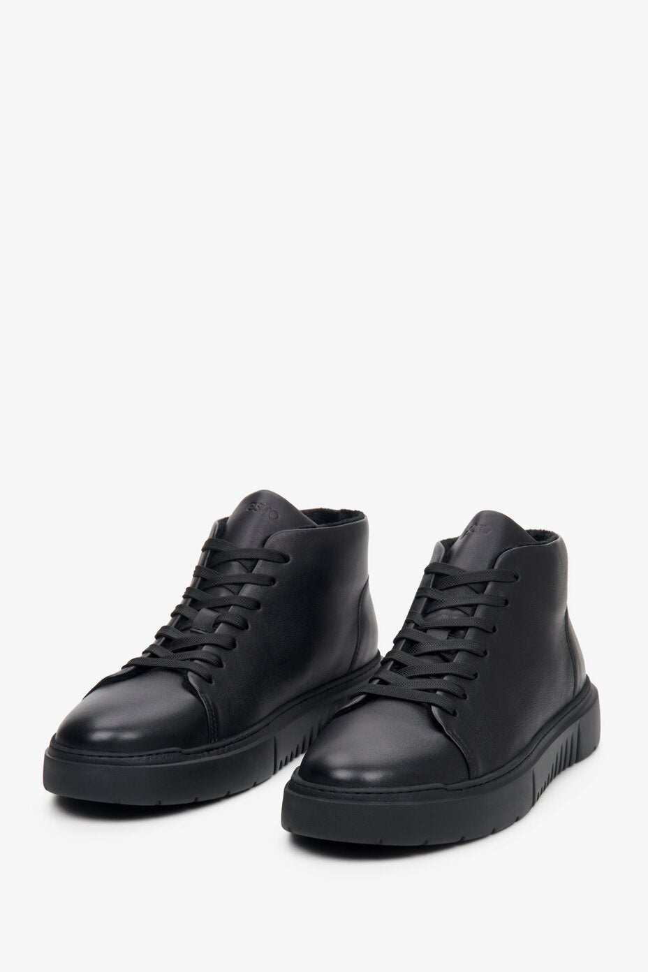 High-top men's sneakers in black with laces, made of leather - presentation of shoe toe.