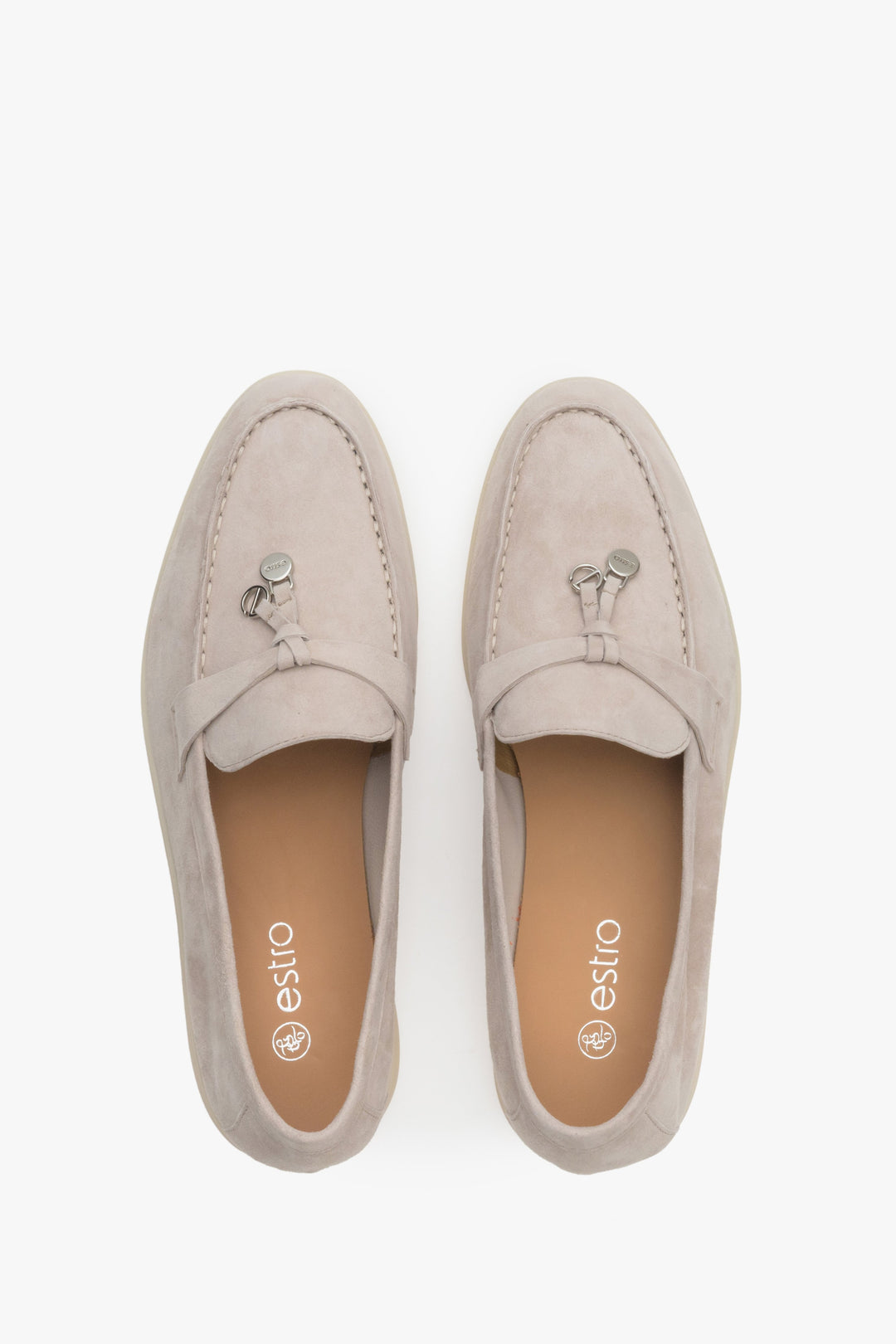 Light beige women's loafers of Estro brand made of velour and leather - presentation of the footwear from above.