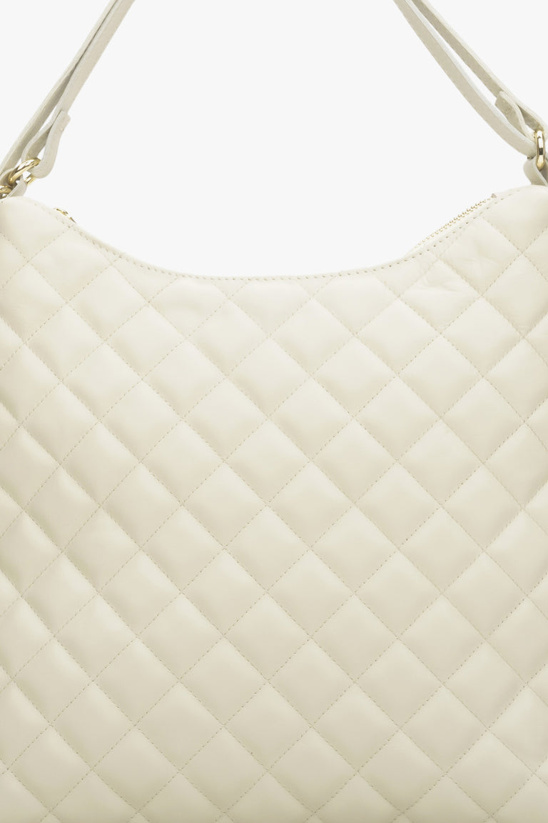 Women's light beige leather quilted handbag.