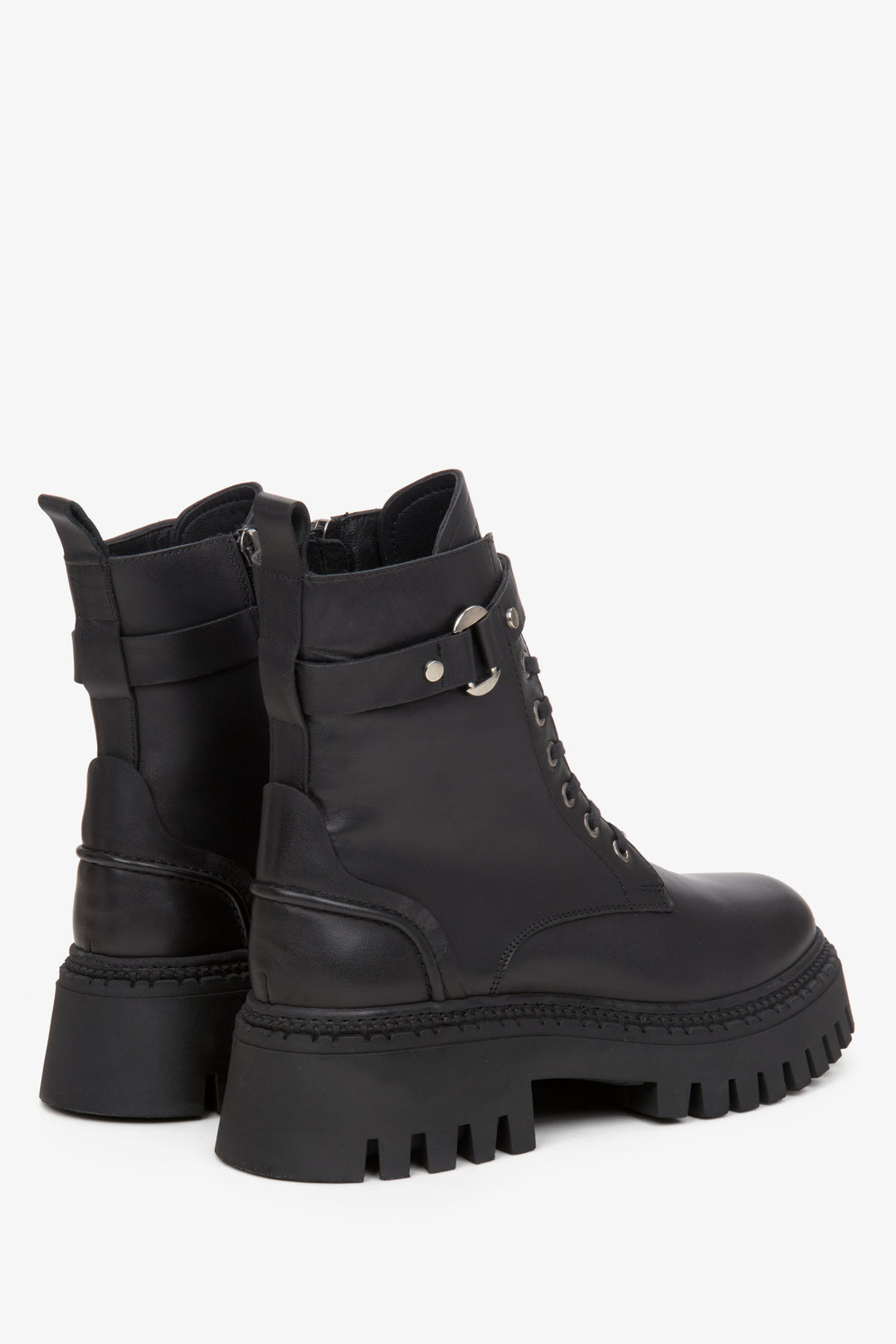 Women's black ankle boots made of genuine leather  - close-up on the heel of the shoe.