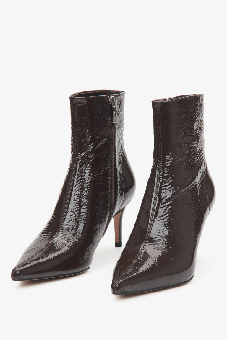 Dark brown patent leather women's ankle boots on a stiletto heel by Estro – close-up of the toe of the shoe.