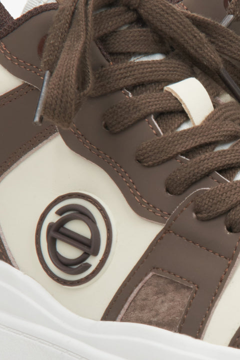 Women's high-top leather sneakers with genuine leather in brown-beige color - close-up on detail.