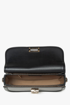Women's black leather handy handbag - close-up of the interior.