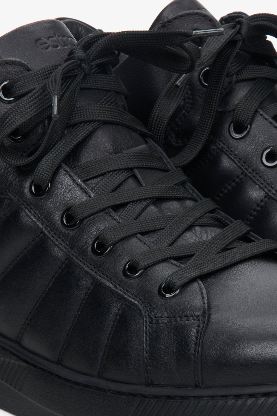 Men's fall leather sneakers in black - close-up of the lacing system.