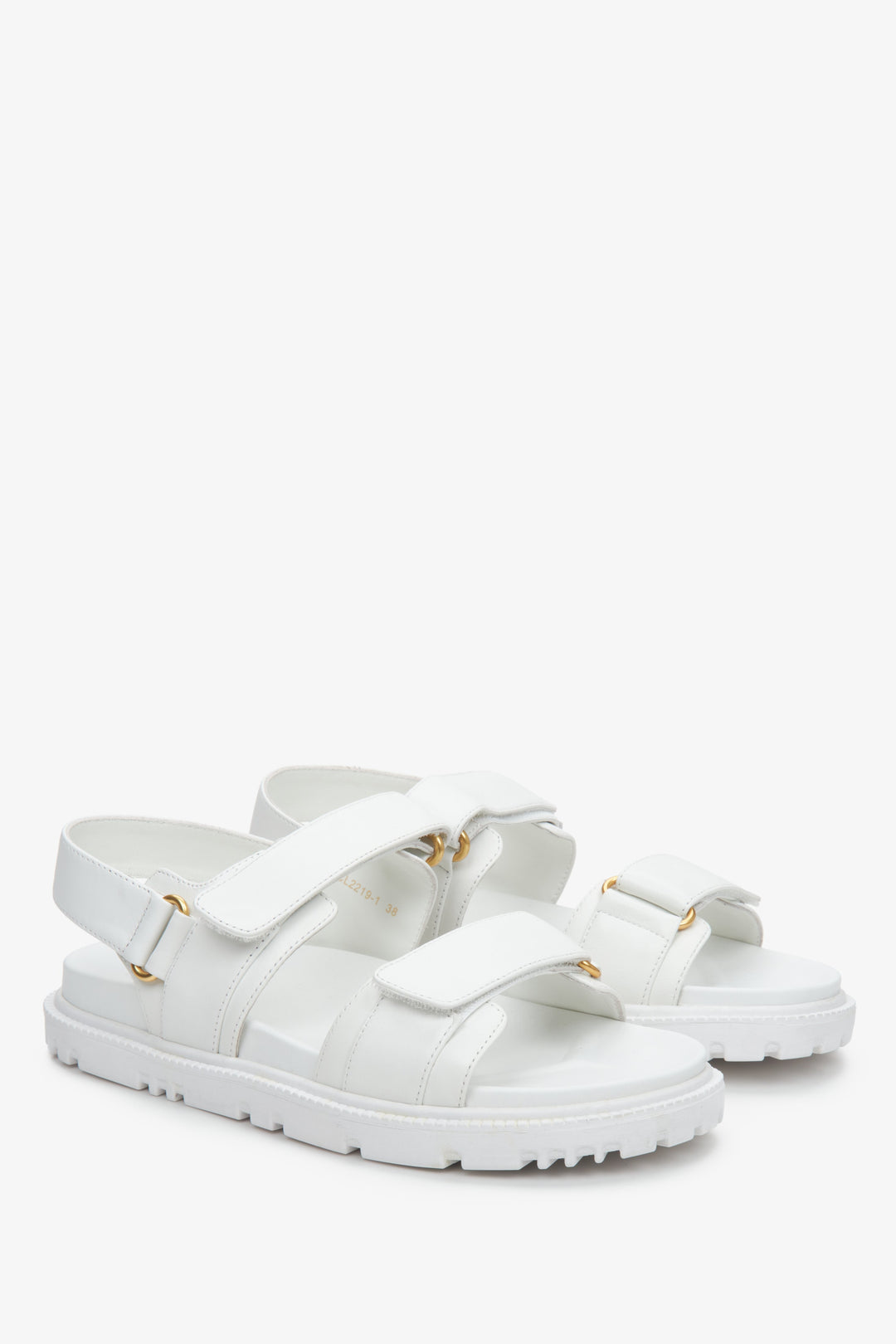 Women's white sandals with a flexible sole and golden embellishments.