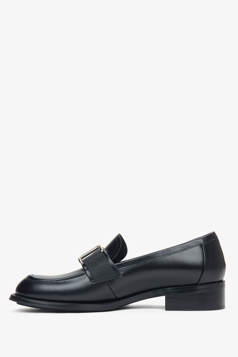 Estro black leather women's penny loafers with a decorative buckle - side view of the shoes.