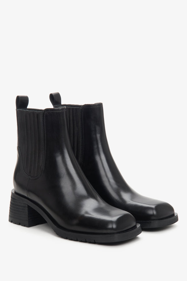 Women's black leather low-heeled chelsea boots.