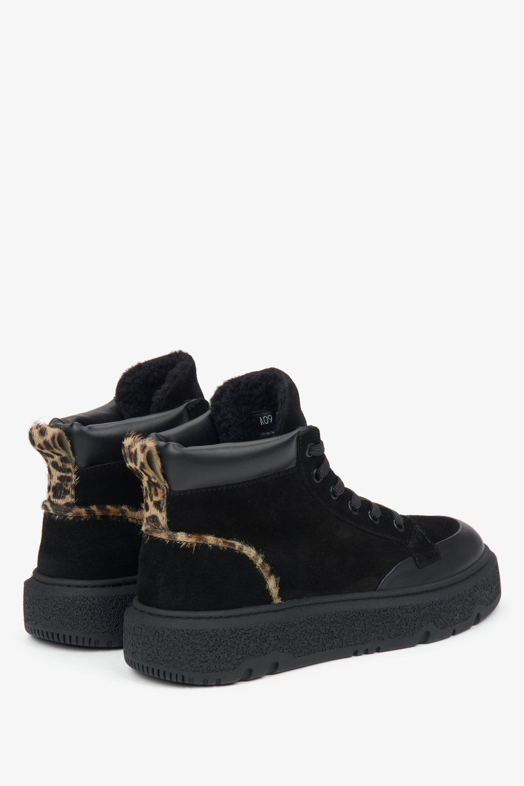 Black high-top winter sneakers for women - close-up of the heel and side line.