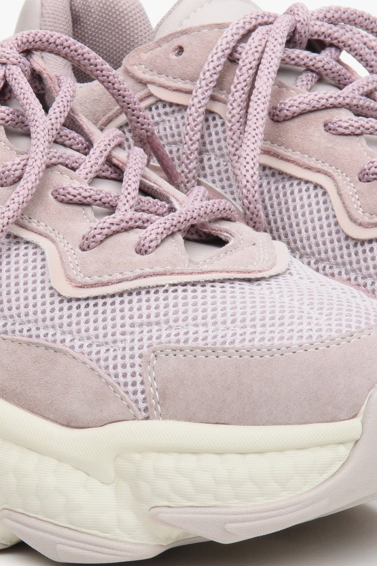 Light violet women's sneakers with suede and textile on a chunky sole - close-up on the details.