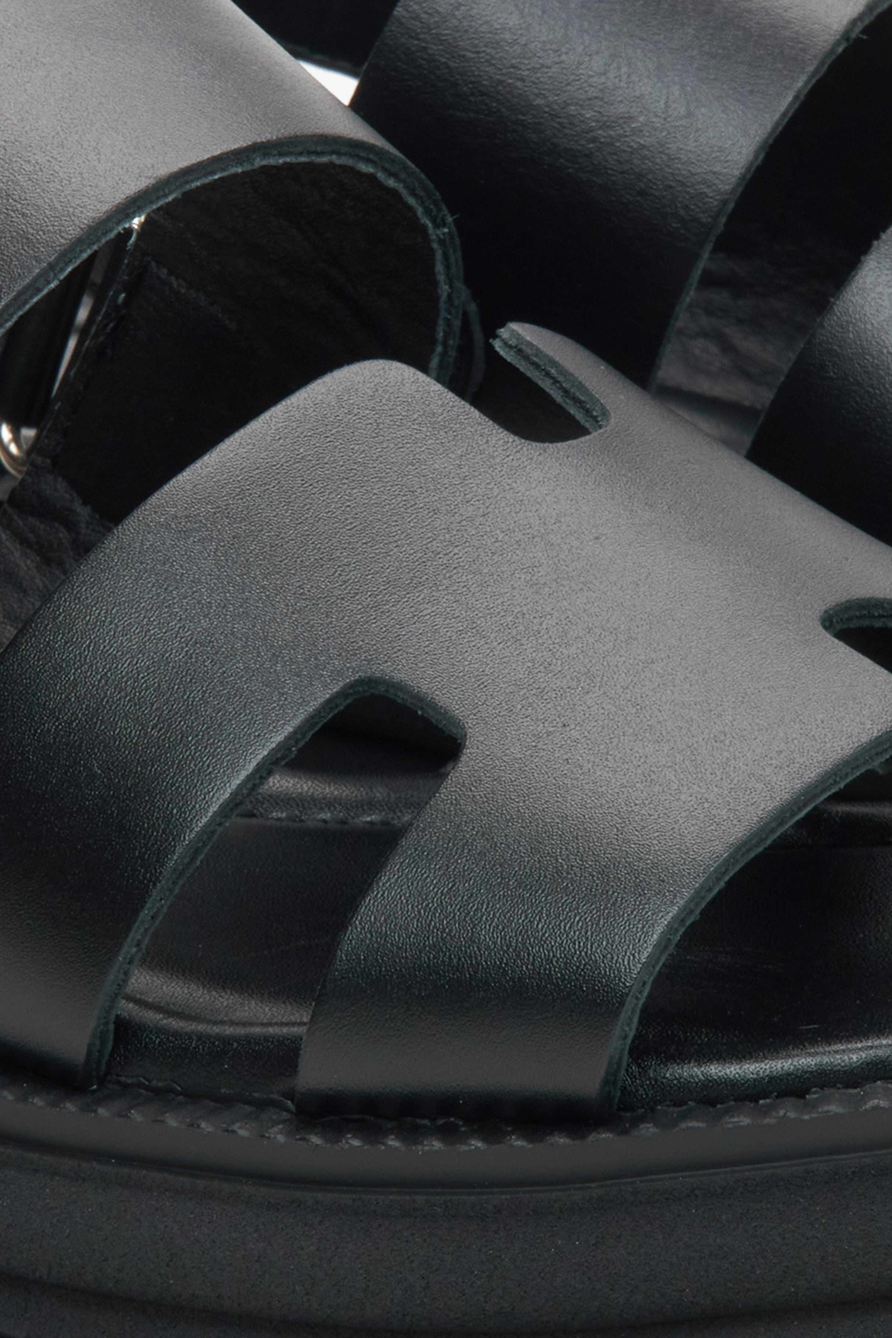 Women's black leather sandals by Estro - close-up detail.