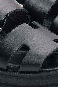 Women's black leather sandals by Estro - close-up detail.