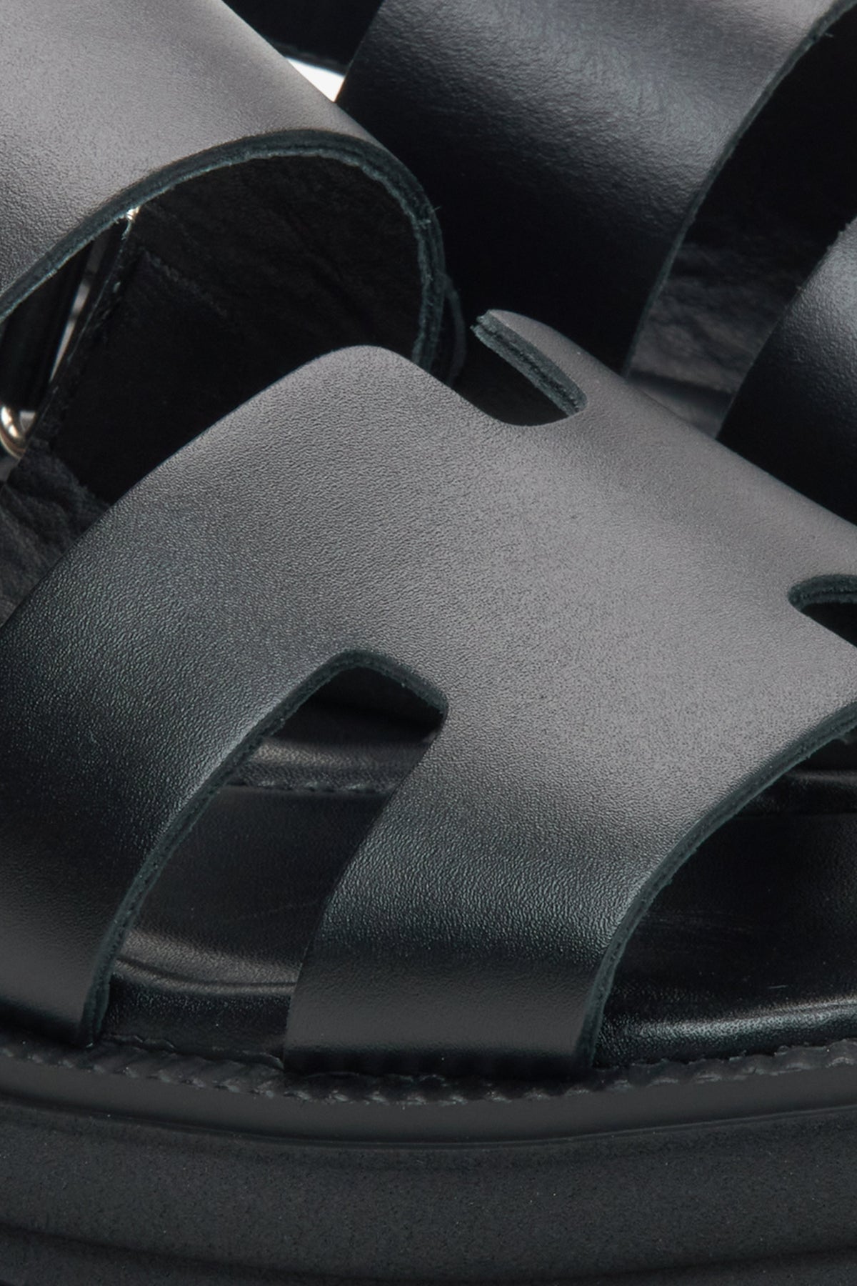 Women's black leather sandals by Estro - close-up detail.