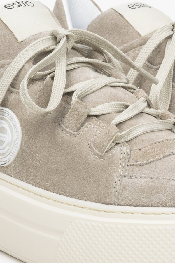 Women's beige sneakers made of genuine velour - close-up on details.