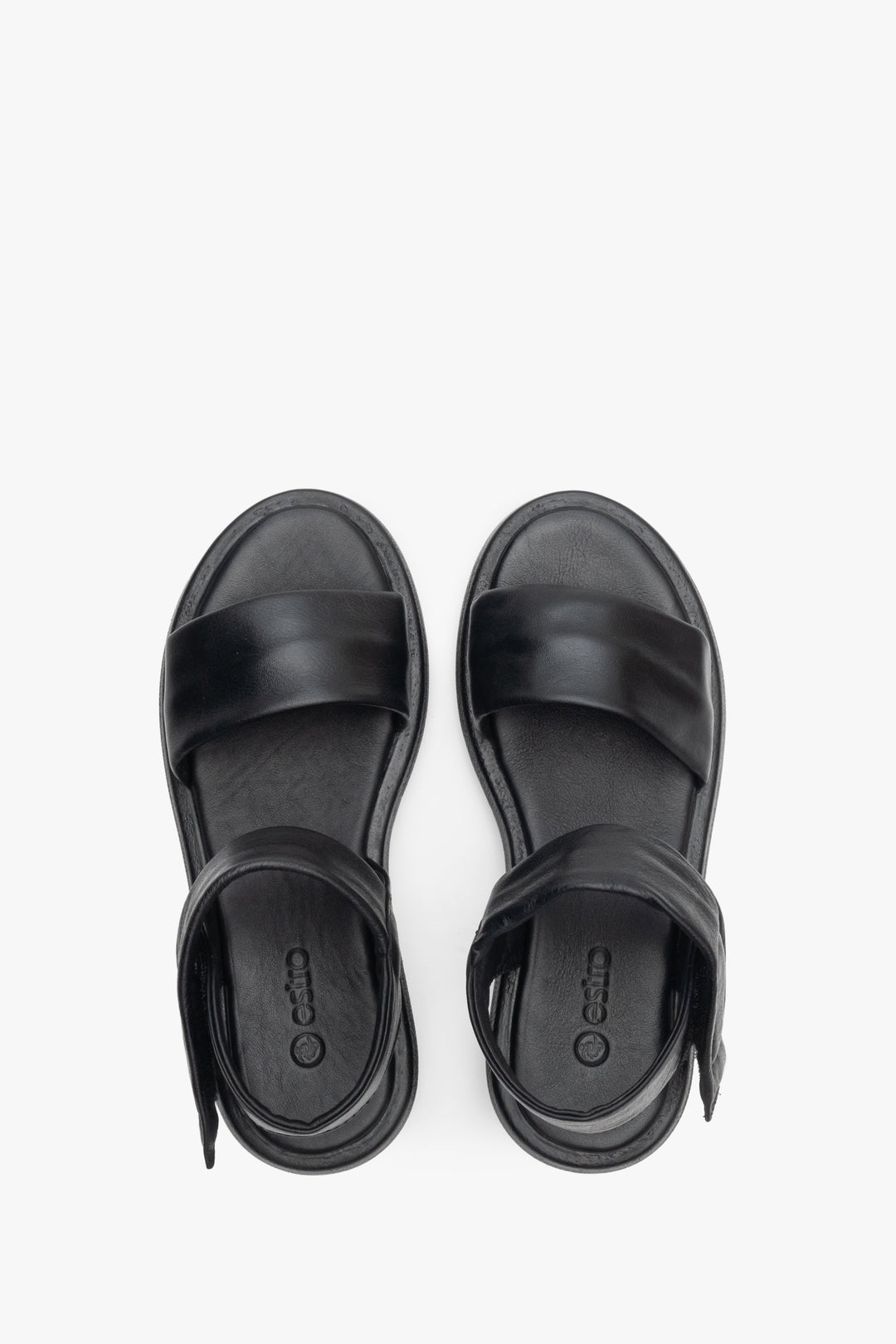 Women's black leather sandals with a low heel - presentation of footwear from above.