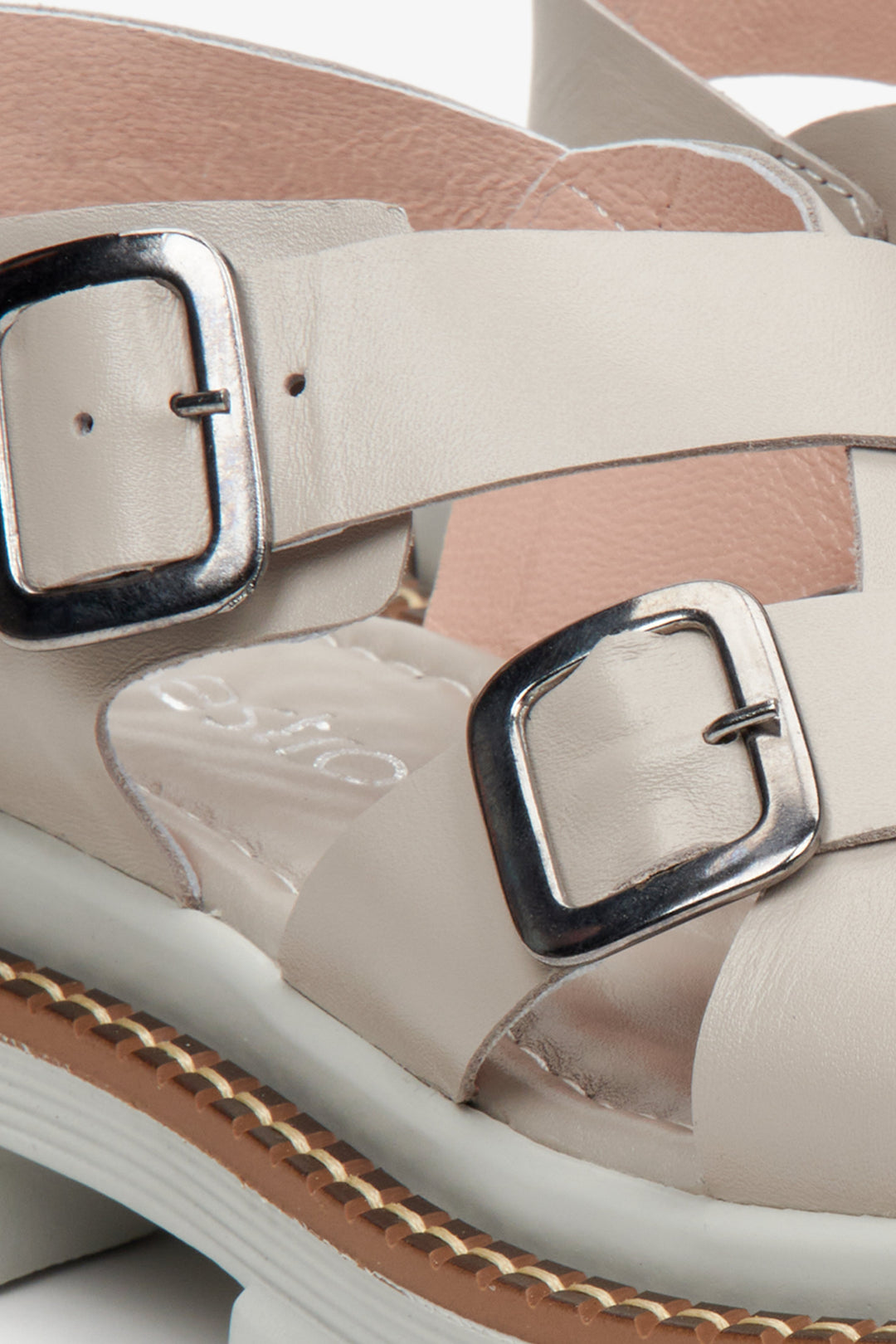 Women's grey leather sandals - a close-up of the fastening and support system.