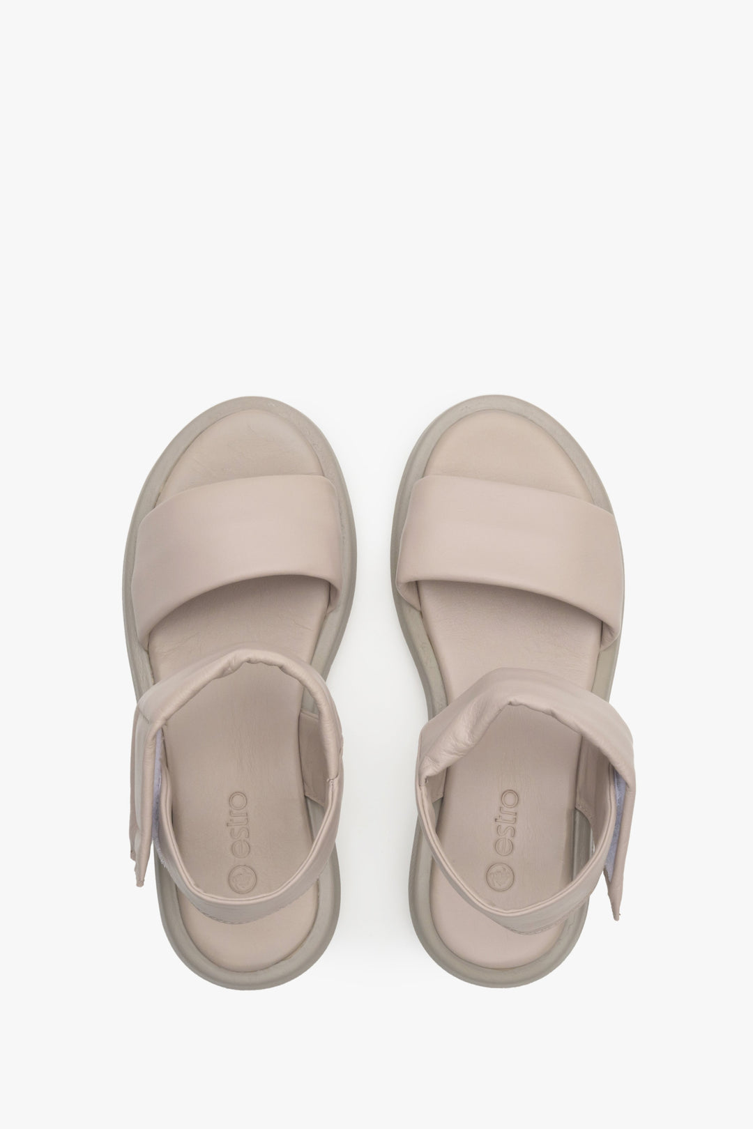 Women's beige leather sandals with a low heel - presentation of footwear from above.