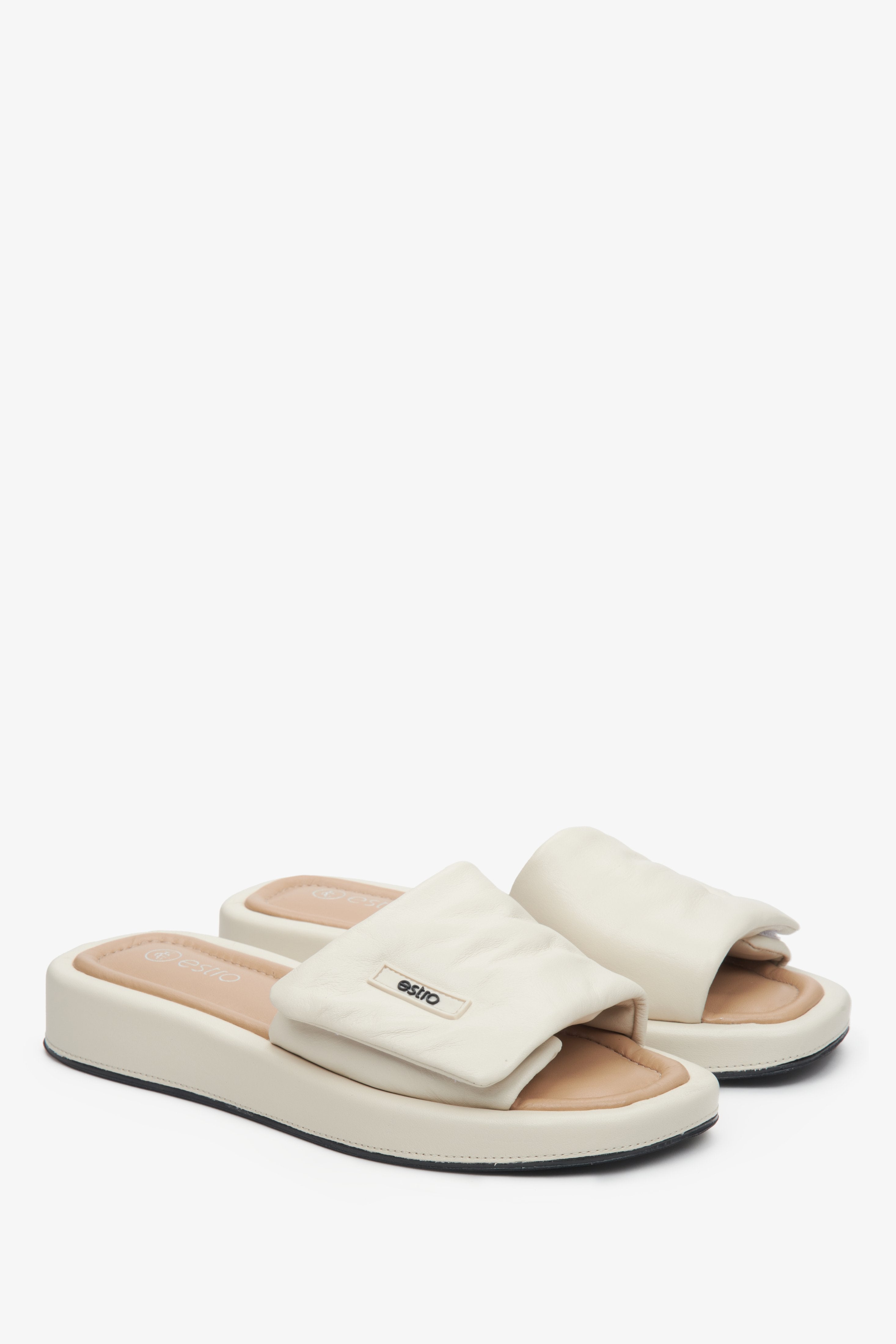 Women's leather slide sandals by Estro in light beige.