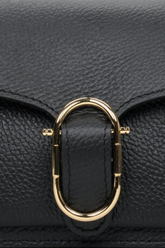 Small black women's handbag - close-up of gold application.