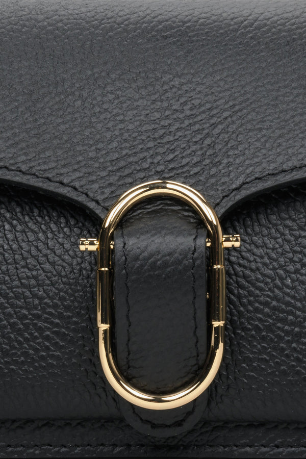 Small black women's handbag - close-up of gold application.