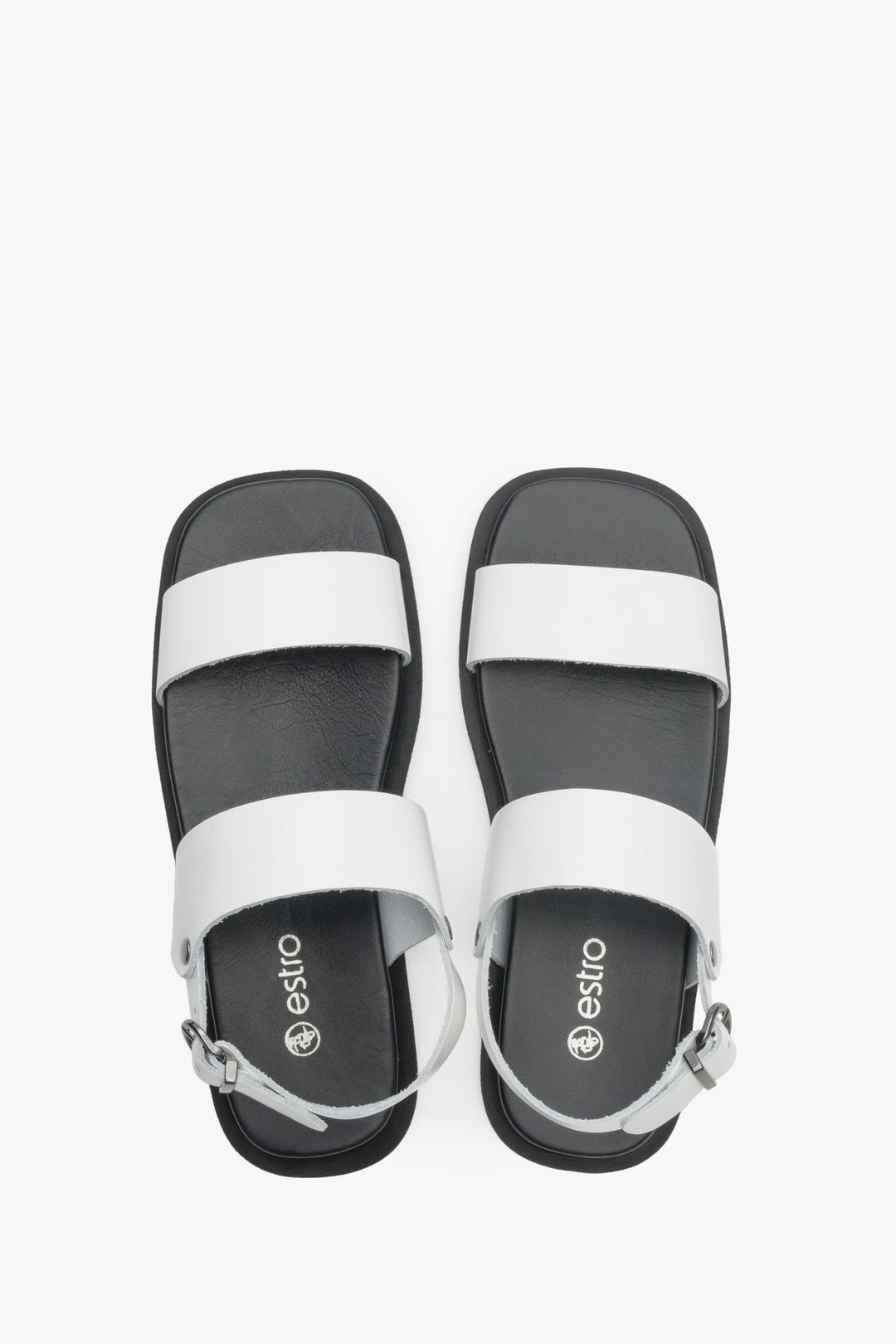Women's sandals in white on a black flat sole Estro - footwear presentation from above.
