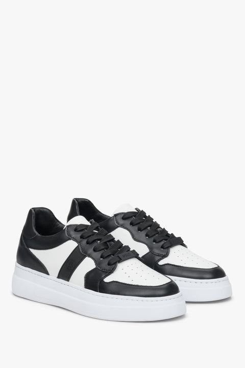White and black women's sneakers in natural leather, laced - presentation of the top and side seam.