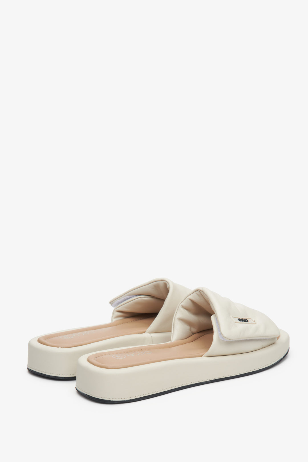 Leather slide sandals by Estro in light beige.