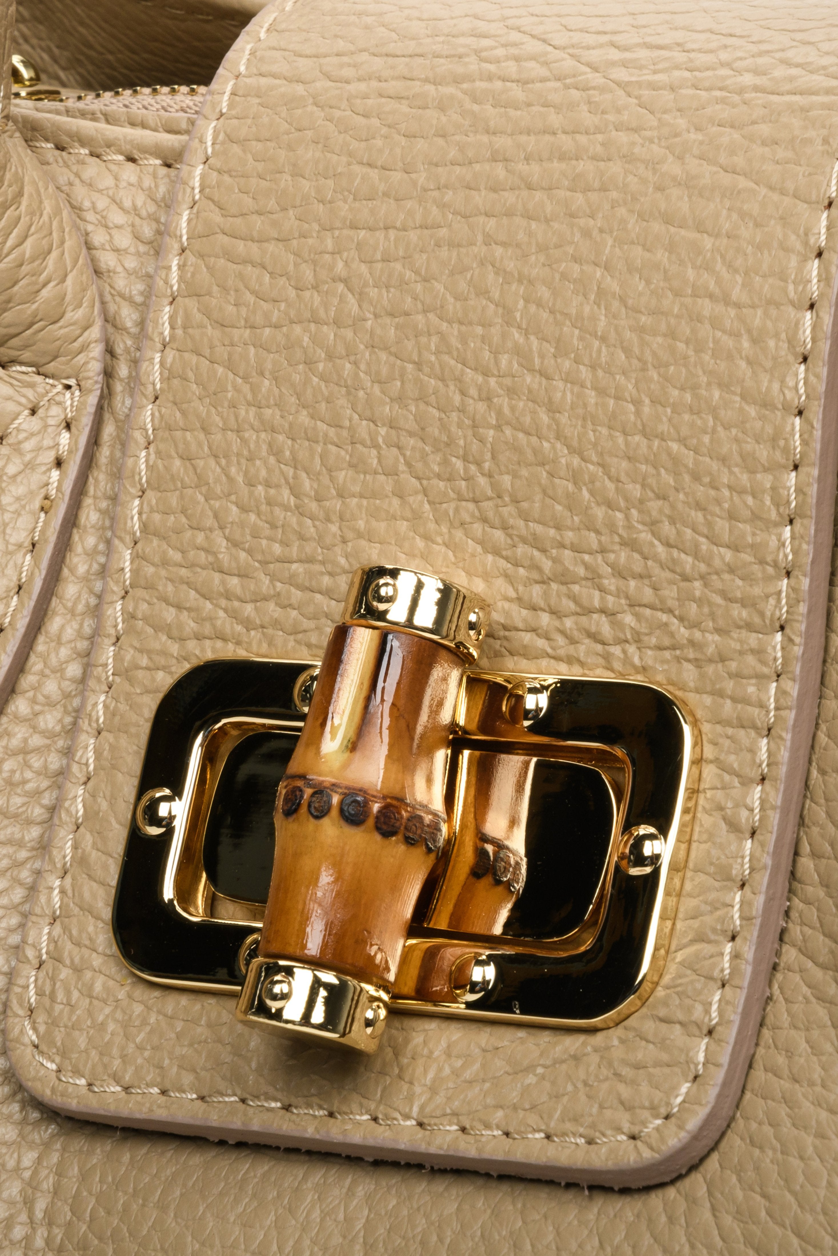 Light brown leather handbag of Italian production. Close-up of the details.